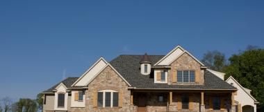 custom home with stone and wood exterior