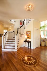 custom wood flooring in foyer and view of second floor staircase