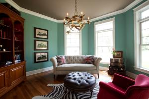 living room with book case, couch, footrest, and armchair
