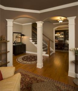 view of foyer from living room with columns