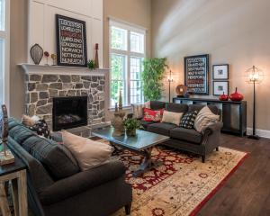 living room with stone fireplace