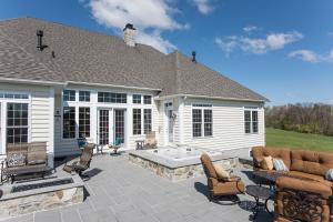 stone patio with fire pit and hot tub