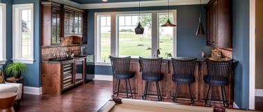 billiard room with built-in wet bar and small kitchen