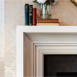 detail of fireplace mantel with wallpaper accewnt