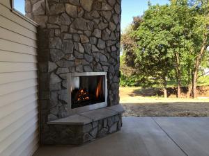 rear porch with built-in fireplace