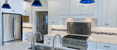 blue glass pendant lights over kitchen island