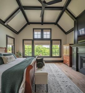 bedroom with sleigh bed fireplace and ceiling trim