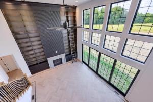 living room with fireplace and wall of windows