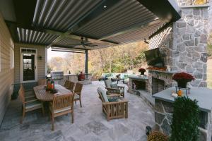 outdoor living area with dining area, fireplace, and outdoor kitchen