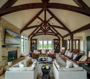 great room with fireplace, pitched ceiling, and exposed arches and beams