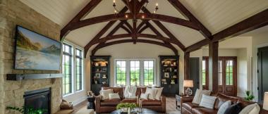 great room with fireplace, pitched ceiling, and exposed arches and beams