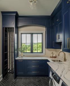 laundry room with sink and blue cabinets