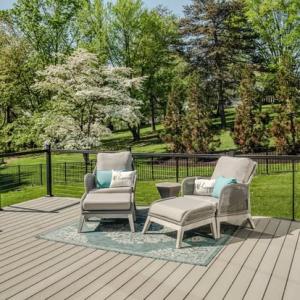 deck with patio furniture and view of backyard with trees