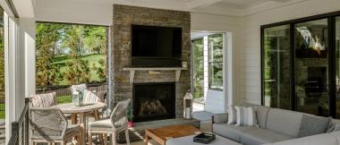 sunroom featuring window walls and fireplace