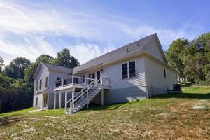 rear view of custom home with elevated deck