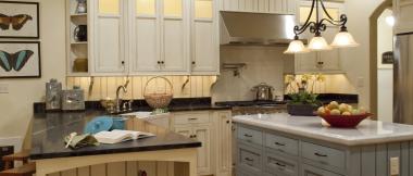 l-shaped kitchen with recessed lights in the ceiling, integrated cabinet lighting, pendant lights over the island